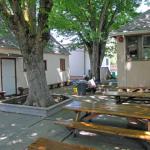 This is the outside lunch and snack area to the right of the pathway that leads to the Persimmon orchard. The building on the left is the Kindergarten classroom and the building on the right is the end of the Discovery Building.
